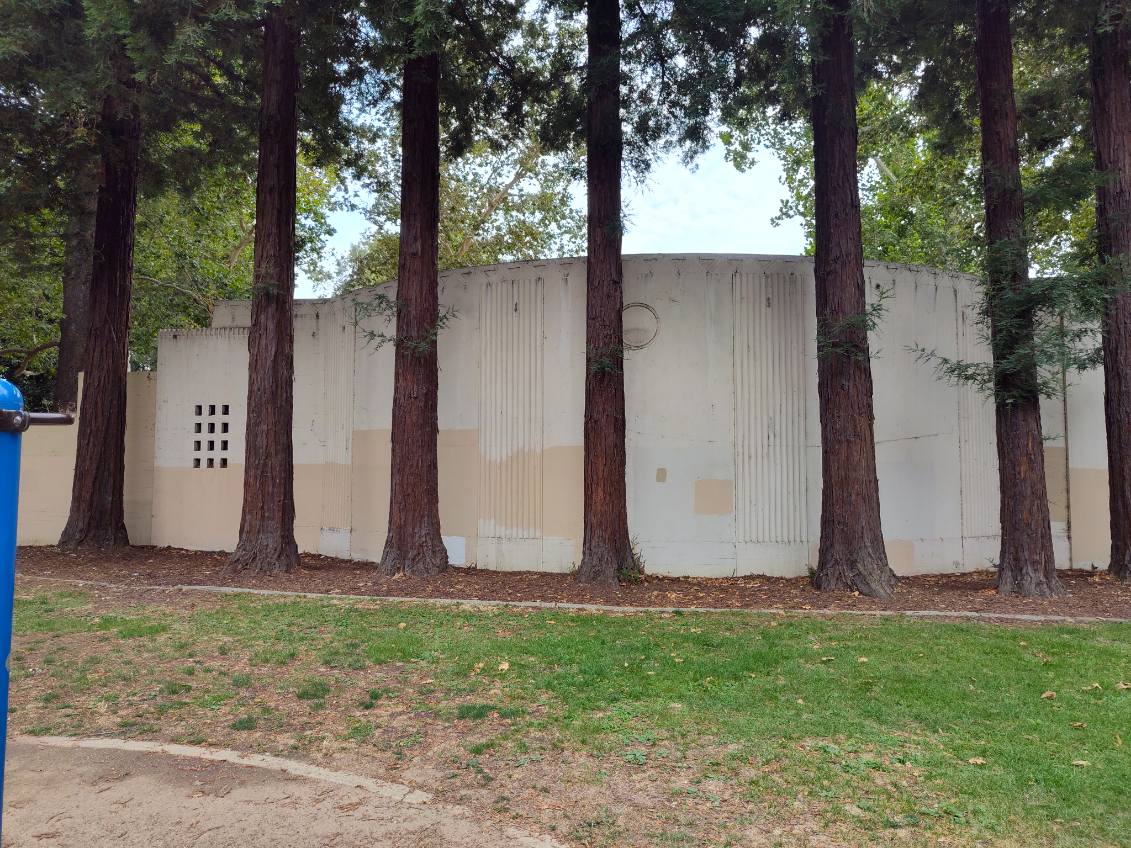 Back, left side of the amphitheater where the new mural will go.